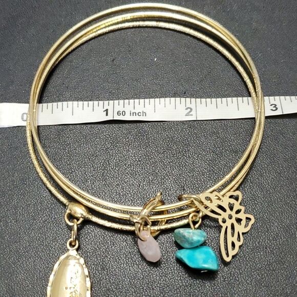 Gold tone layered bracelet with charms - Picture 8 of 9